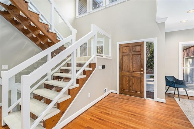 foyer entrance featuring recessed lighting, visible vents, baseboards, stairs, and light wood-type flooring