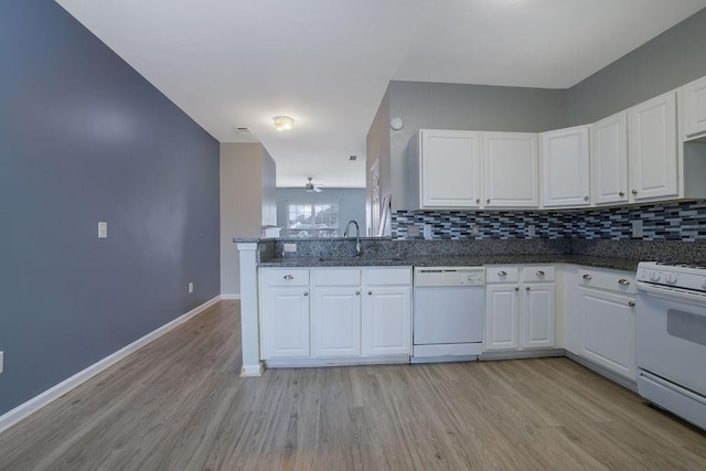 kitchen featuring white cabinetry, sink, white appliances, and decorative backsplash