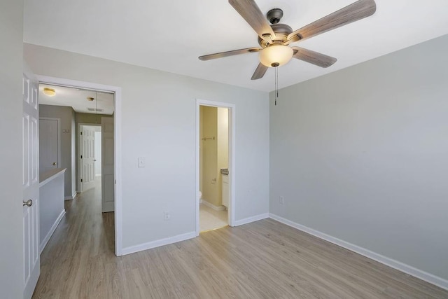 unfurnished bedroom with ceiling fan, light wood-type flooring, and ensuite bath