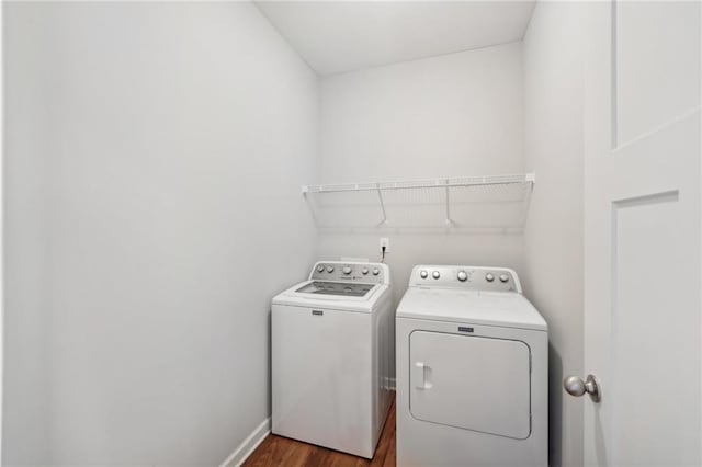 laundry area featuring dark wood-type flooring and separate washer and dryer