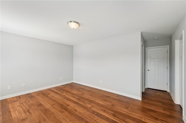 empty room featuring dark wood-type flooring