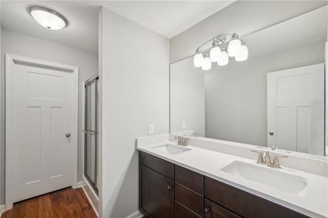 bathroom with vanity, wood-type flooring, and a shower with shower door