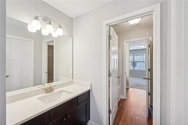 bathroom with vanity and hardwood / wood-style flooring