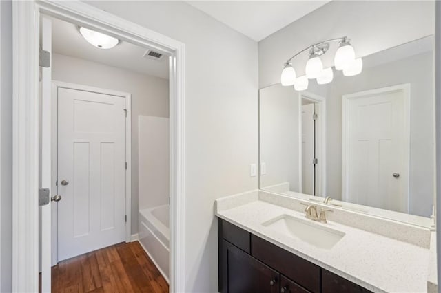 bathroom with vanity, shower with separate bathtub, and wood-type flooring