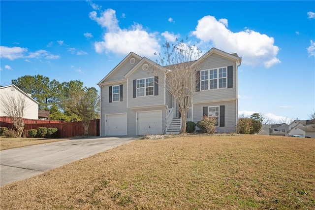 view of front of home featuring concrete driveway, a front lawn, an attached garage, and fence