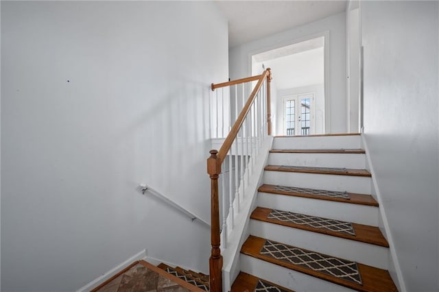 stairway featuring baseboards