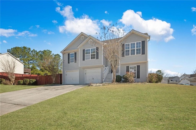 split foyer home with driveway, a front lawn, and fence