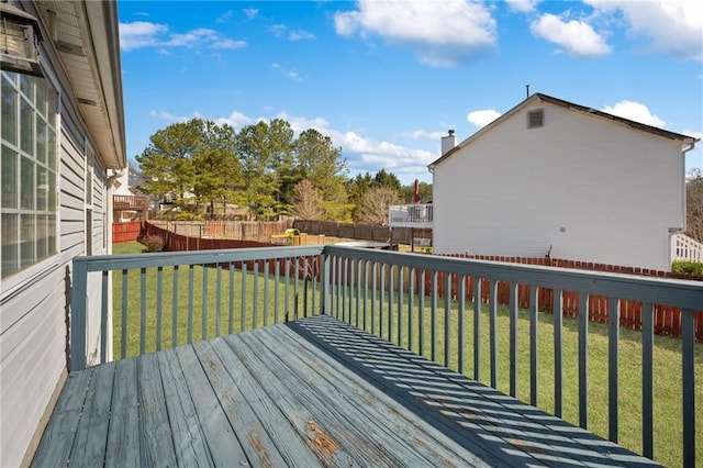 wooden deck featuring a fenced backyard and a yard