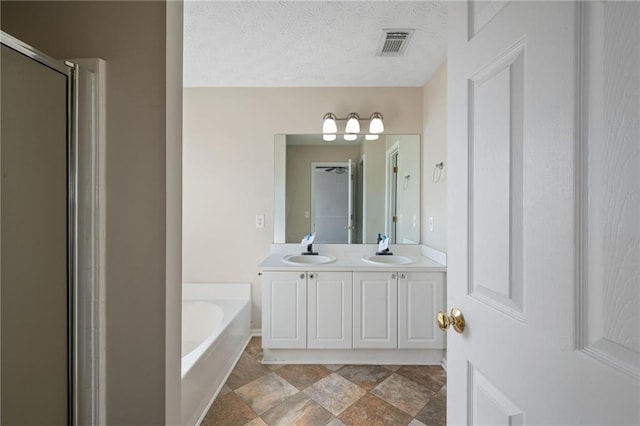 full bathroom with a stall shower, visible vents, a sink, and a garden tub