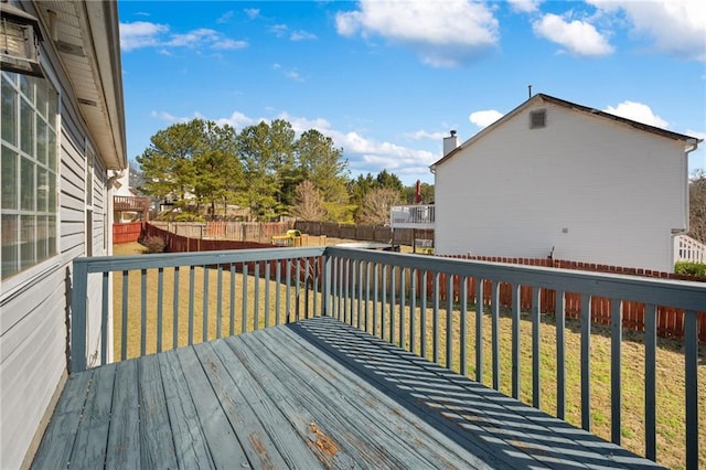 wooden deck featuring a yard and a fenced backyard