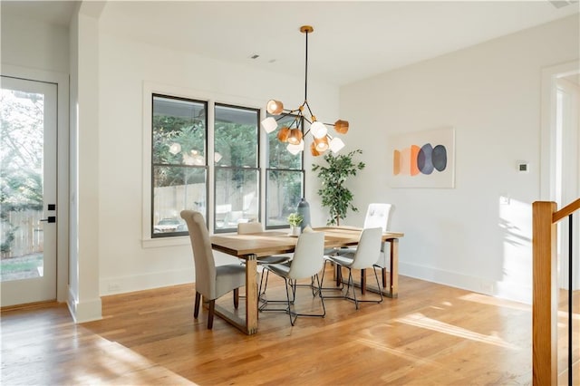 dining room featuring an inviting chandelier and light wood-type flooring