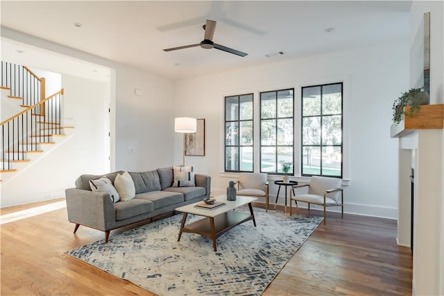 living room featuring hardwood / wood-style floors and ceiling fan