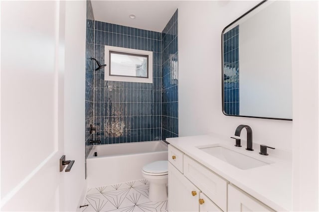 full bathroom with vanity, tiled shower / bath combo, and toilet