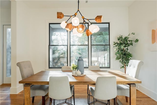 dining room featuring hardwood / wood-style flooring and a notable chandelier