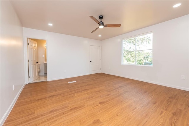 interior space with baseboards, recessed lighting, light wood-style flooring, ensuite bathroom, and a ceiling fan