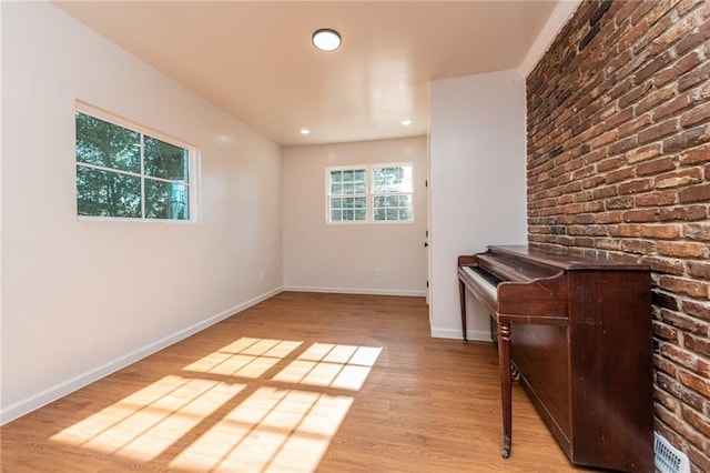 spare room featuring wood finished floors, baseboards, and recessed lighting