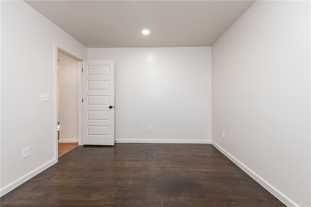 unfurnished room with wood finished floors, baseboards, and recessed lighting