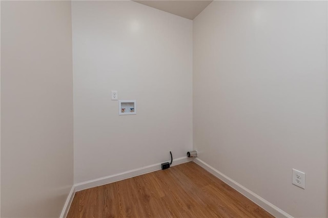 laundry room with light wood-style flooring, hookup for a washing machine, laundry area, and baseboards