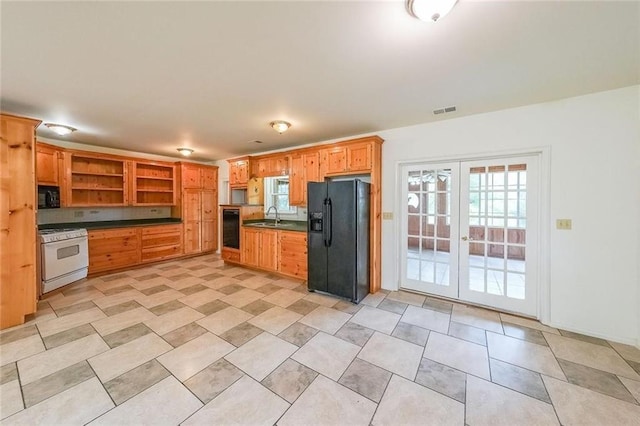 kitchen with black appliances, french doors, and sink