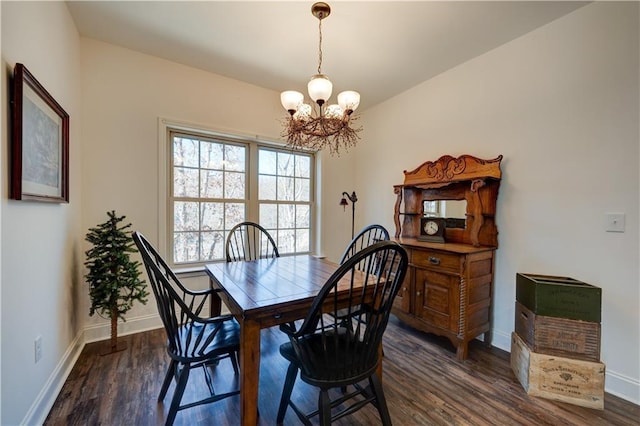 dining room with baseboards, dark wood-type flooring, and a notable chandelier