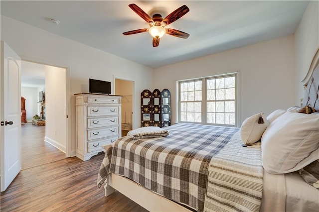 bedroom with baseboards, a ceiling fan, and wood finished floors