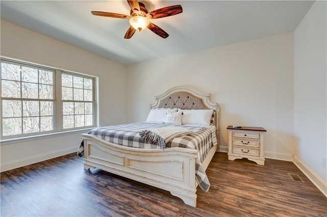 bedroom featuring dark wood-type flooring, baseboards, and a ceiling fan