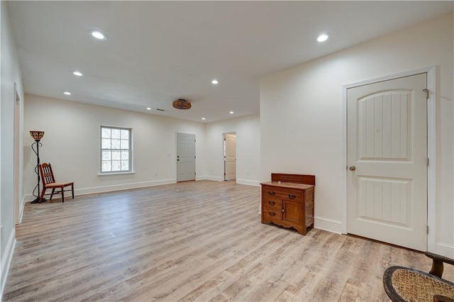 spare room with light wood-type flooring, baseboards, and recessed lighting