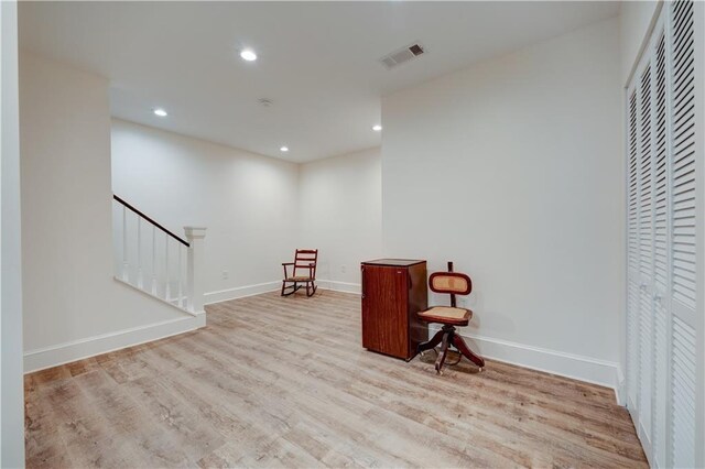 sitting room featuring baseboards, visible vents, wood finished floors, stairs, and recessed lighting