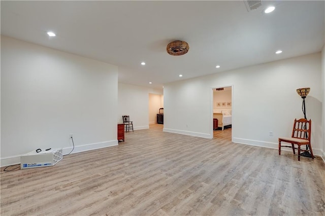 interior space featuring baseboards, light wood finished floors, visible vents, and recessed lighting