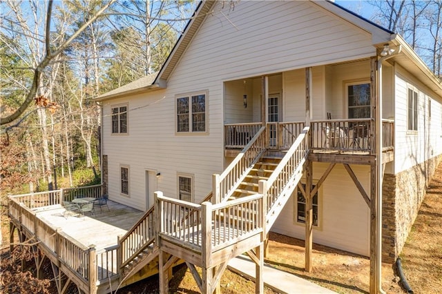 rear view of property with stairs and a deck