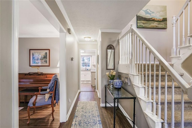 entrance foyer with stairs, crown molding, baseboards, and wood finished floors