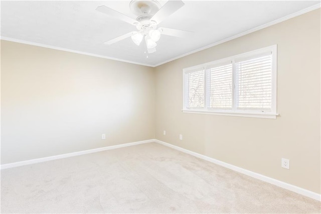 empty room featuring ornamental molding, light colored carpet, and ceiling fan