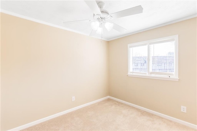 carpeted spare room featuring ornamental molding and ceiling fan