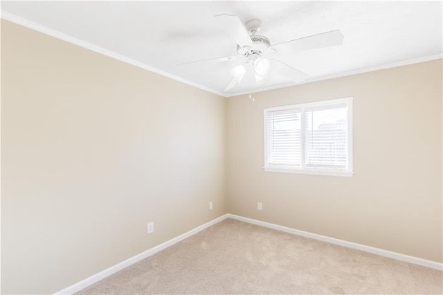 carpeted empty room with crown molding and ceiling fan