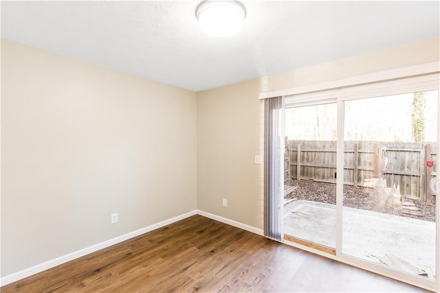 unfurnished room featuring hardwood / wood-style flooring