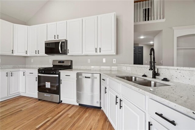 kitchen with white cabinetry, sink, and appliances with stainless steel finishes