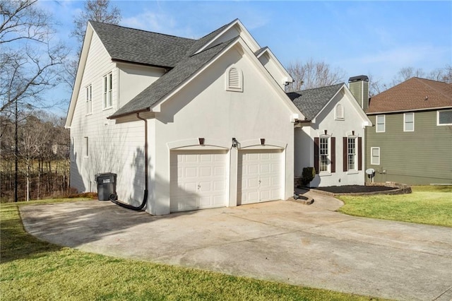 view of side of home with a garage and a lawn