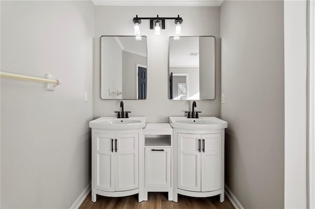 bathroom with ornamental molding, vanity, and hardwood / wood-style floors