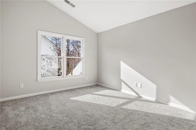 empty room featuring lofted ceiling and carpet flooring