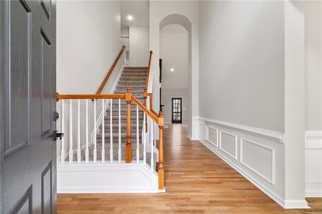 stairs featuring hardwood / wood-style floors