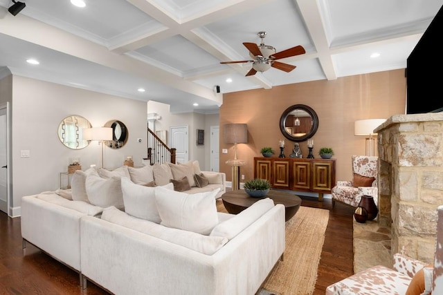 living room with beam ceiling, dark wood-type flooring, ceiling fan, crown molding, and coffered ceiling