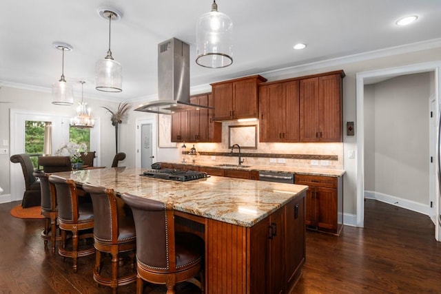 kitchen with black gas stovetop, island exhaust hood, sink, hanging light fixtures, and crown molding