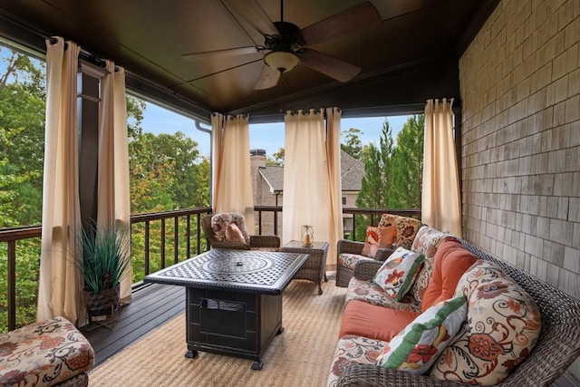 sunroom / solarium featuring ceiling fan