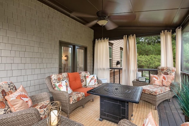 sunroom featuring ceiling fan