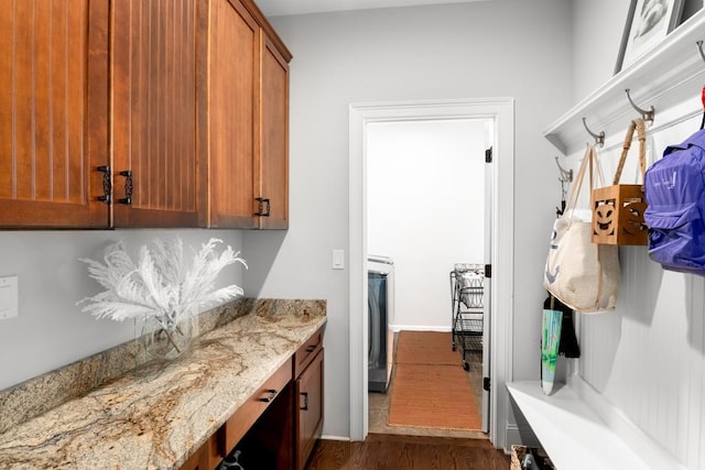 interior space with dark hardwood / wood-style flooring and washer / dryer