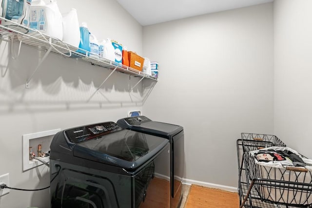 washroom with independent washer and dryer and hardwood / wood-style flooring