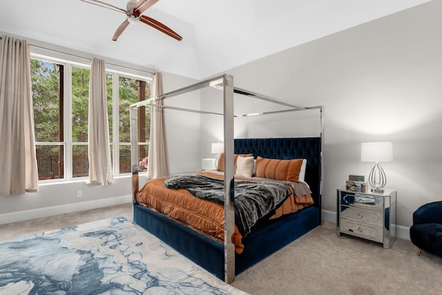 bedroom with ceiling fan, light carpet, and vaulted ceiling