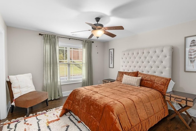 bedroom with ceiling fan and dark wood-type flooring