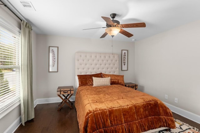 bedroom with ceiling fan and dark hardwood / wood-style flooring