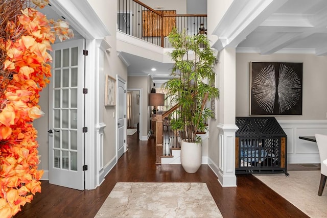 foyer entrance with dark hardwood / wood-style flooring, beamed ceiling, crown molding, and coffered ceiling